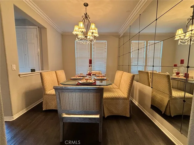 an open kitchen with granite countertop a stove and a wooden floors
