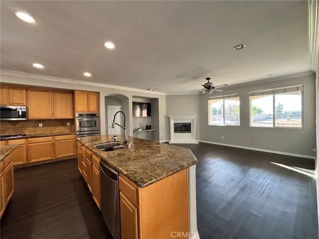 a kitchen with sink refrigerator and stove