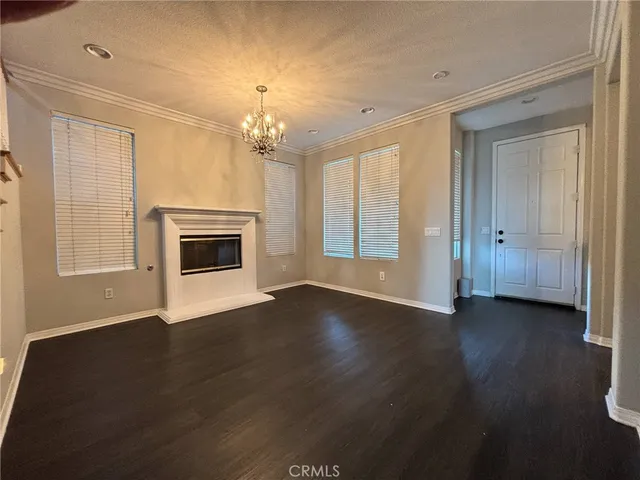 a living room with furniture a chandelier and a fireplace