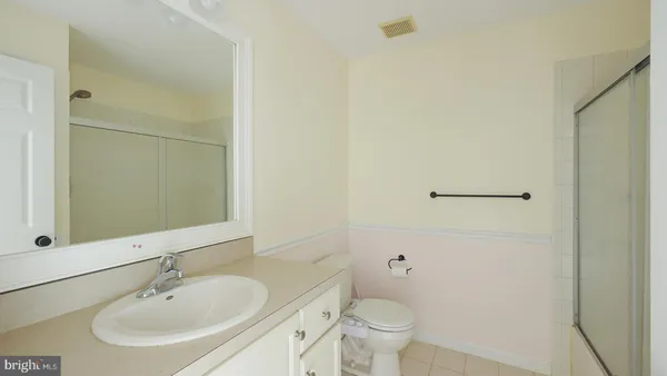 a bathroom with a sink toilet and a mirror
