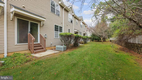 a view of a house with backyard and a tree