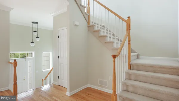 a view of entryway with wooden floor and a front door