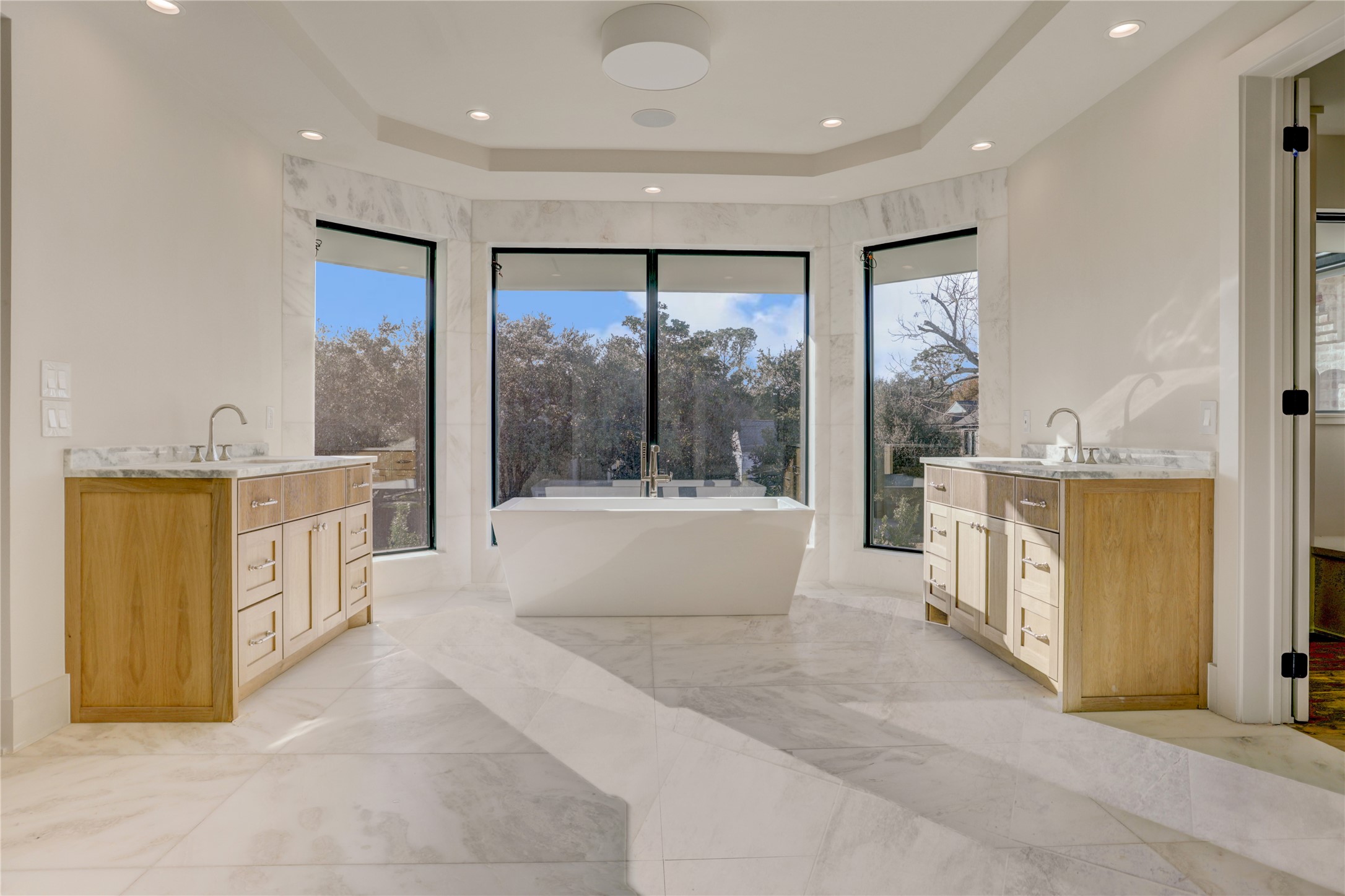 2250 Sunset Boulevard Houston, TX 77005 - Photo 22 of 40 The primary bath is such a relaxing space. Large floor to ceiling windows allow tons of light but also have a privacy setting to darken them from the outside.