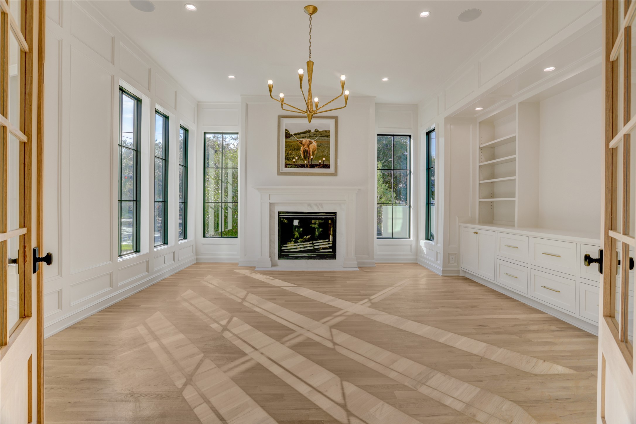 2250 Sunset Boulevard Houston, TX 77005 - Photo 3 of 40 Entering through the white oak doors, the study has a gas log fireplace, built-ins, and a gorgeous light fixture. Don't miss the hidden closet for concealed storage on your left. All windows are triple-paned to keep this room insulated from exterior noise.