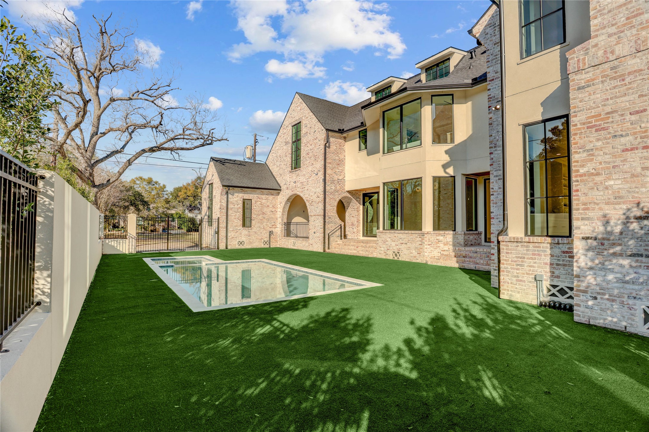 2250 Sunset Boulevard Houston, TX 77005 - Photo 39 of 40 The turfed backyard is serene and has endless possibilities. Heated pool/hot tub. 8-ft privacy wall with eagleston holly trees lining the exterior wall.