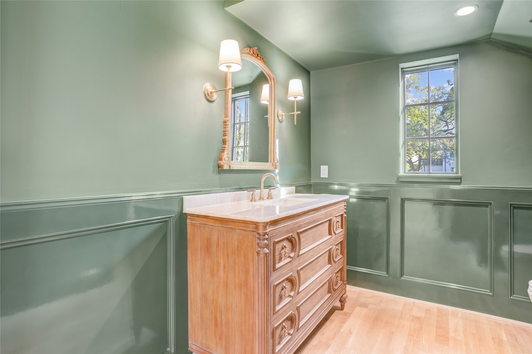 2250 Sunset Boulevard Houston, TX 77005 - Photo 6 of 40 The powder room is tucked under the stairs with deep green high gloss paint, a repurposed antique buffet converted to a sink, sconces, and a lovely mirror.