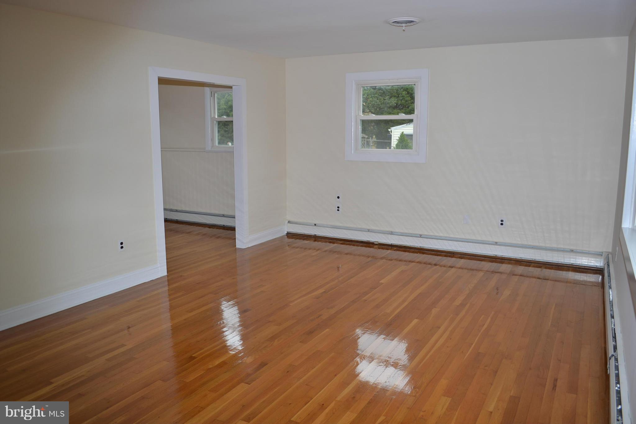 155 Brewster Bridge Road Elkton, MD 21921 - Photo 11 of 30 an empty room with wooden floor and windows