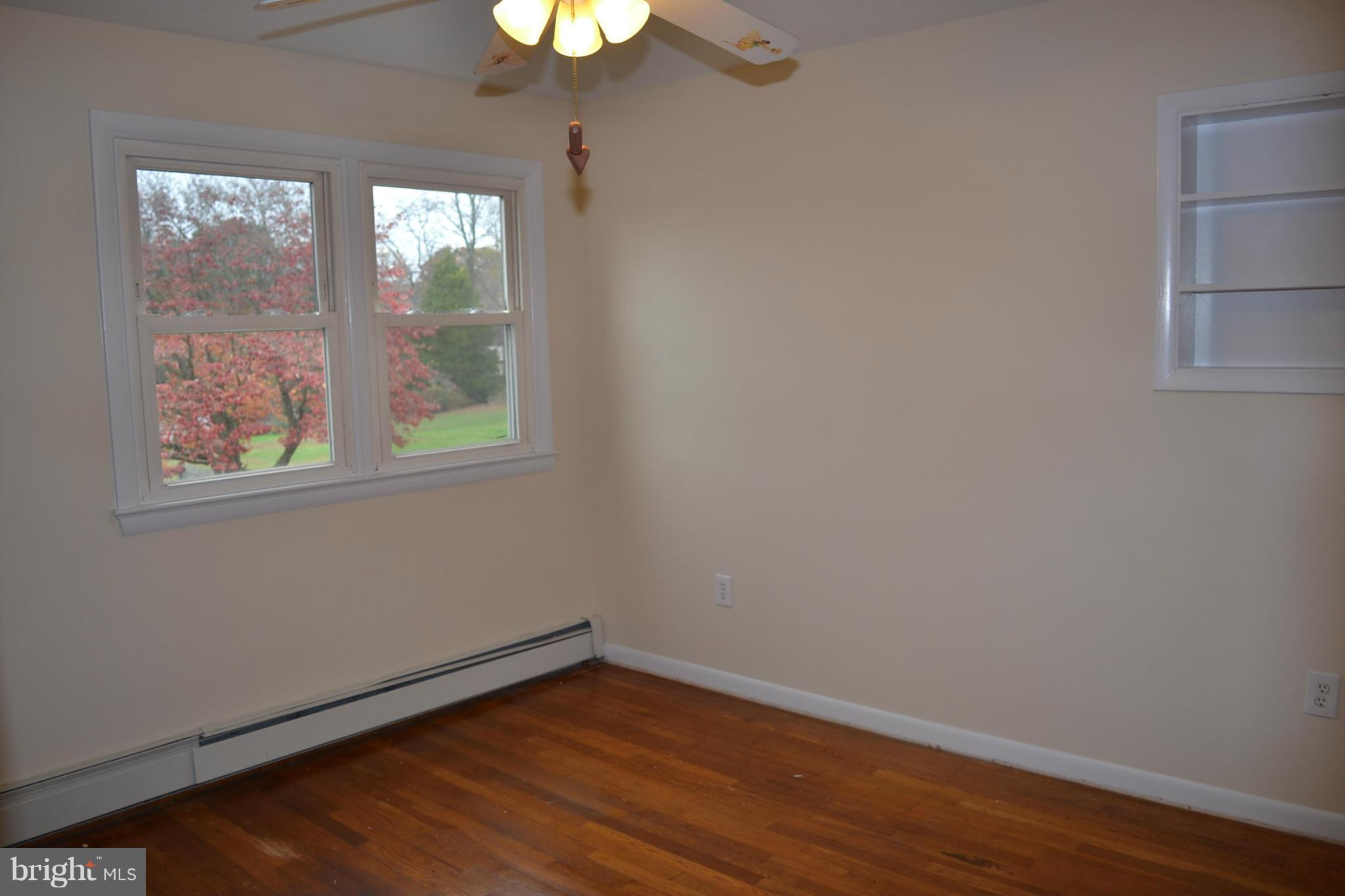 155 Brewster Bridge Road Elkton, MD 21921 - Photo 14 of 30 a view of an empty room with wooden floor and a window