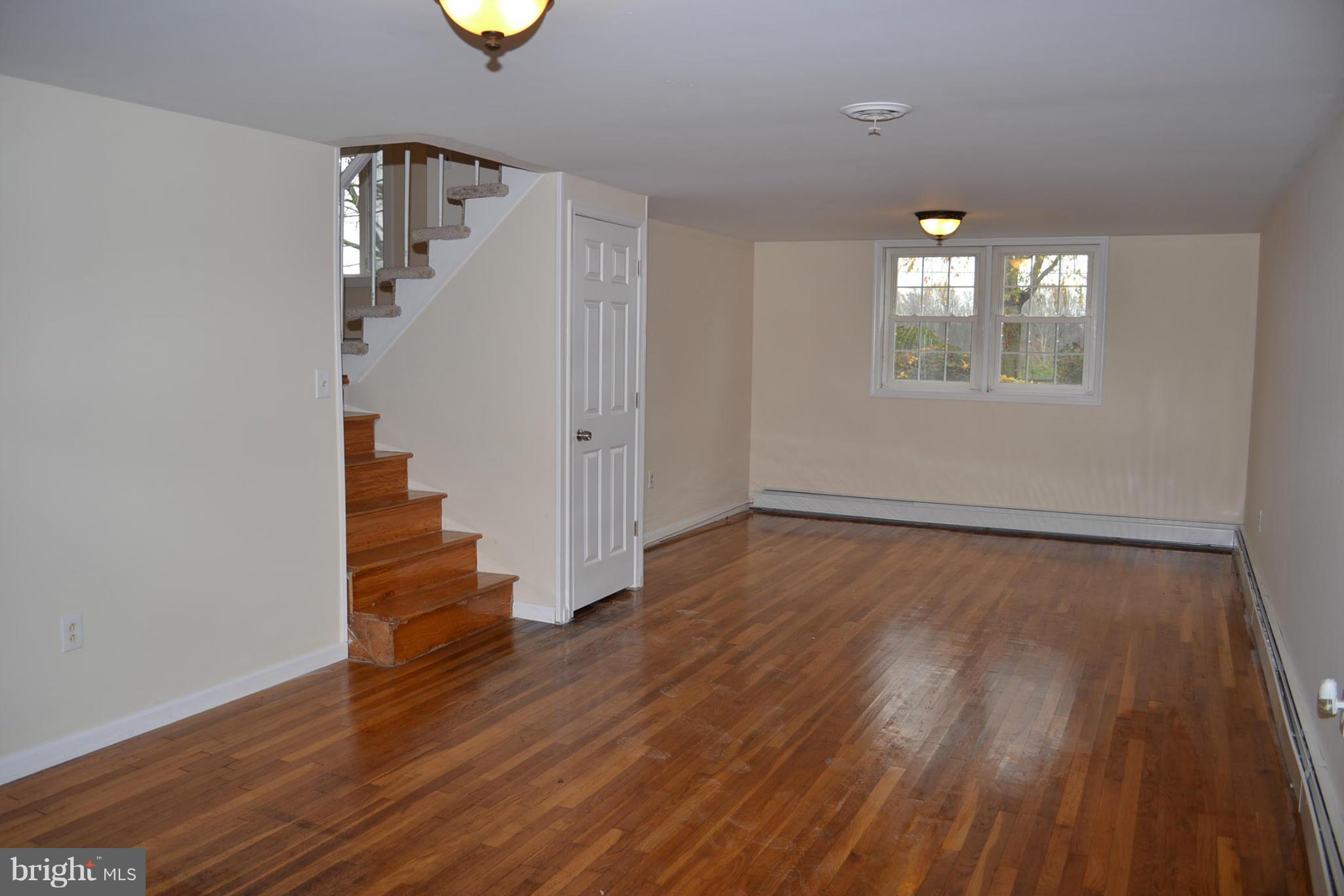 155 Brewster Bridge Road Elkton, MD 21921 - Photo 4 of 30 wooden floor in an empty room with a window