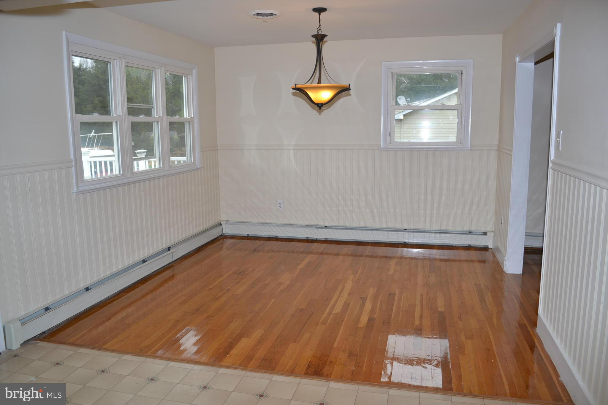 155 Brewster Bridge Road Elkton, MD 21921 - Photo 5 of 30 a view of a room with wooden floor and windows