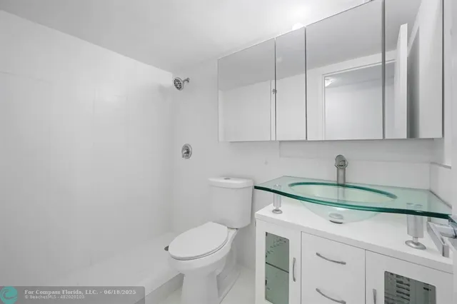 a bathroom with a sink a toilet and vanity