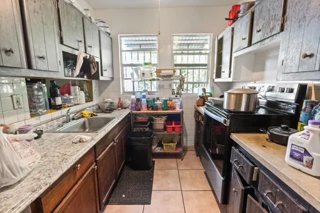 a kitchen that has a sink a stove and a oven