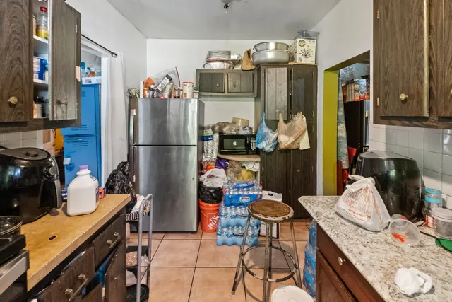 a kitchen with stainless steel appliances granite countertop a refrigerator and a stove