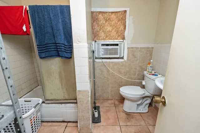 a bathroom with a toilet and a shower
