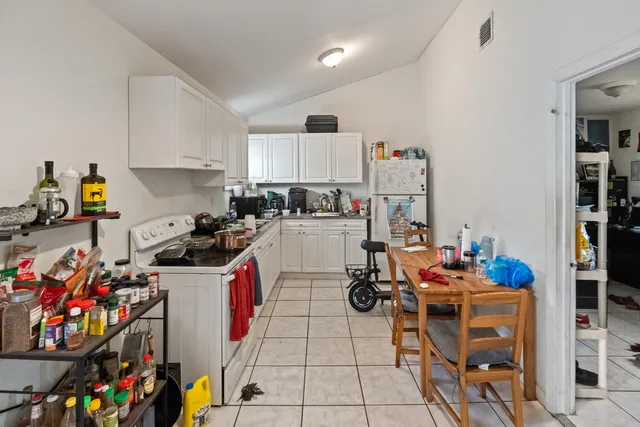 a kitchen that has a lot of appliances and cabinets