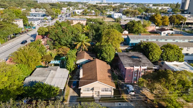an aerial view of multiple houses with yard