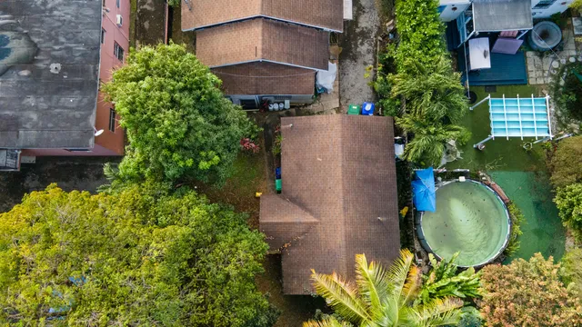 an aerial view of a house with a yard and garden