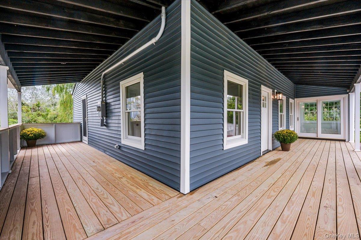 56 Oak Beach Road Babylon, NY 11702 - Photo 5 of 30 New deck that wraps around the covered front porch.