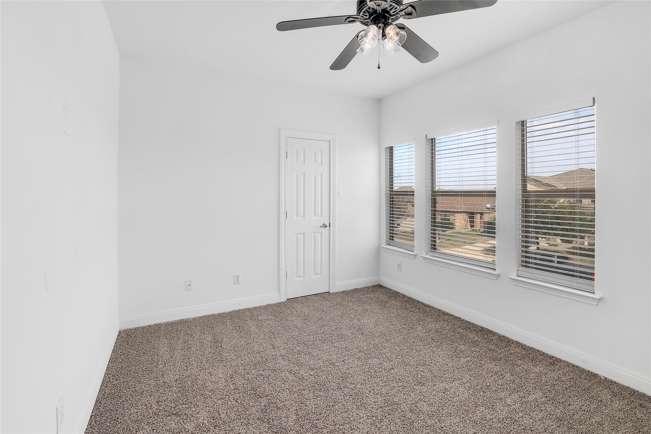 203 Ran Road Leander, TX 78641 - Photo 21 of 31 Plentiful natural light streams through multiple windows across the plush carpeted floor.