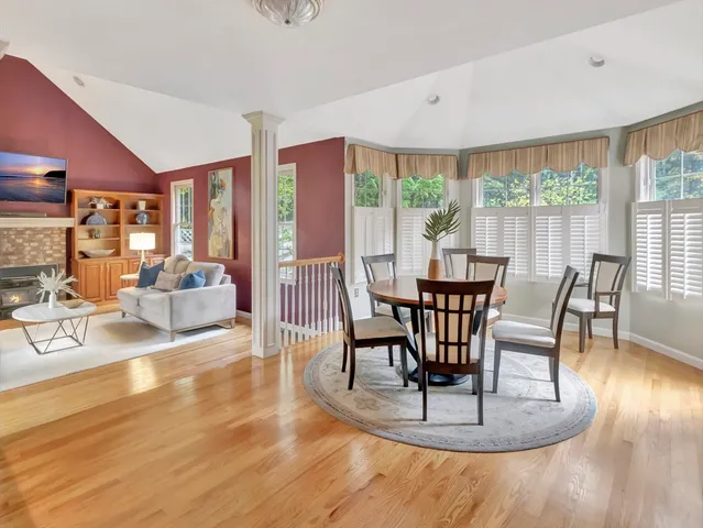 a view of a dining room with furniture wooden floor and a chandelier