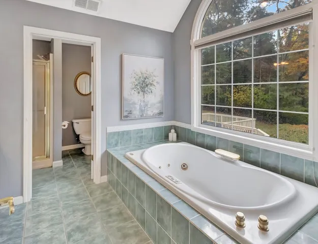 a bath tub sitting next to a blue sink