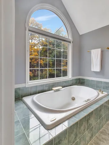 a bath tub sitting in a bathroom next to a window