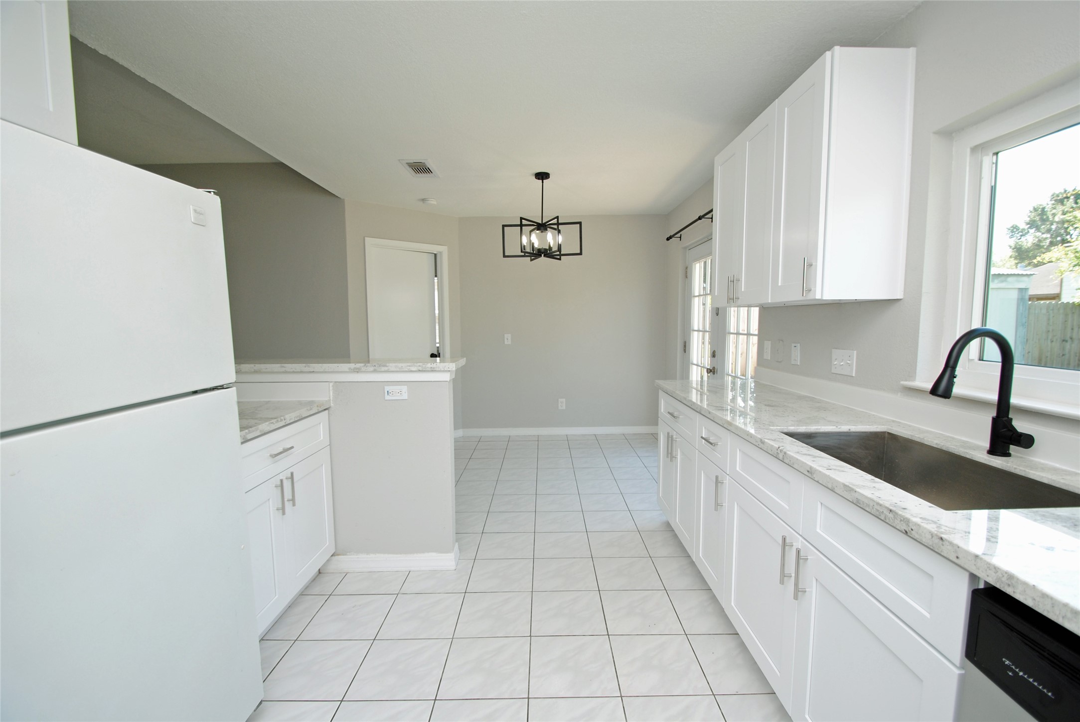 22831 John Rolfe Lane Katy, TX 77449 - Photo 11 of 34 a kitchen with a sink a refrigerator and cabinets