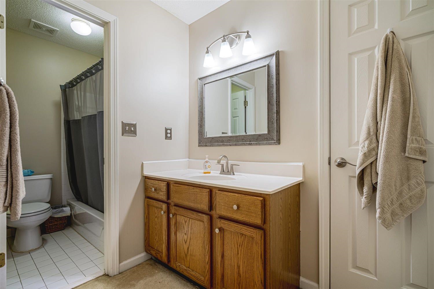 1489 John Ridge Drive Collierville, TN 38017 - Photo 34 of 39 a bathroom with a toilet sink and mirror