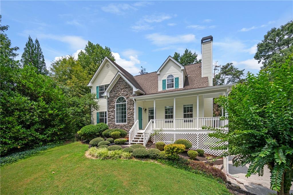 2060 Pilgrim Mill Circle Cumming, GA 30041 - Photo 1 of 1 a front view of a house with a yard and potted plants