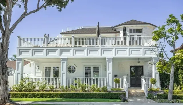front view of a brick house with a yard
