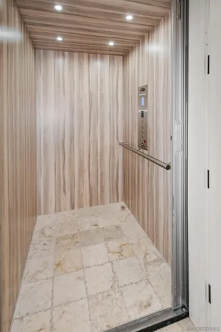 a bedroom with a bed lamps and a large mirror