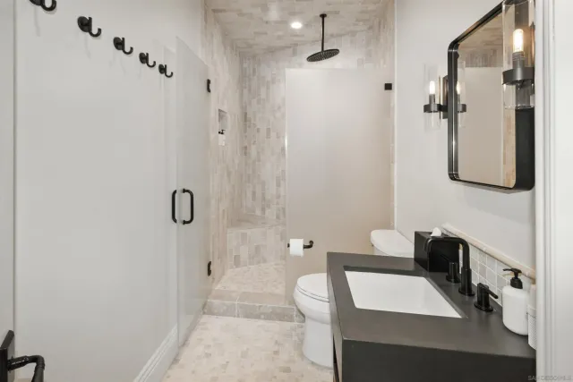 a white toilet sitting next to a bathroom sink