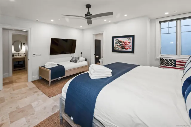 a living room with furniture a flat screen tv and a window