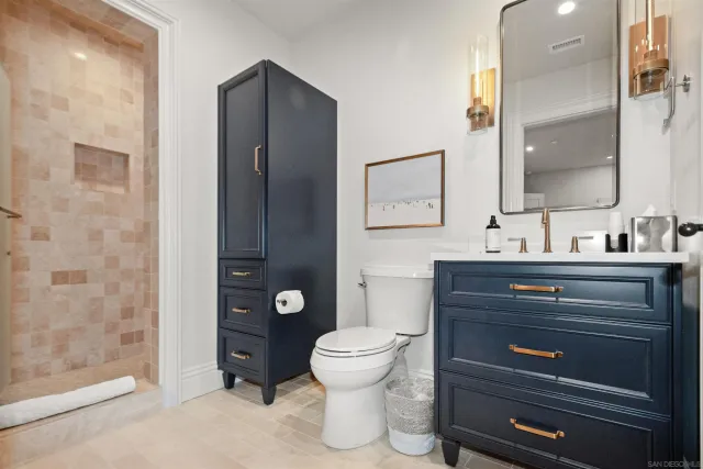 a kitchen with a sink a counter and chairs in it