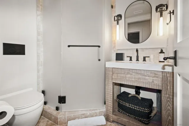 a bedroom with a large bed and a fireplace