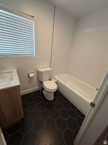 287 100 North Orem, UT 84057 - Photo 12 of 18 Bathroom featuring vanity, dark tile patterned flooring, and bathtub / shower combination