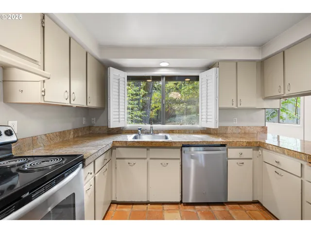 a kitchen with a cabinets a stove and a window