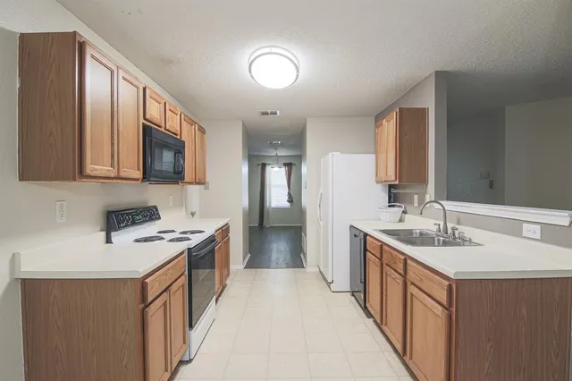 a kitchen with a stove top oven sink and cabinets