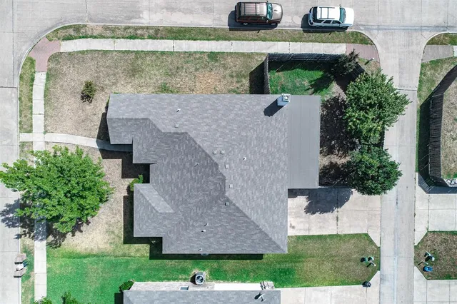 an aerial view of a house with a yard