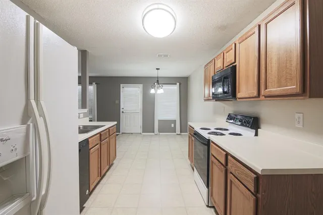 a kitchen with a sink stove and refrigerator