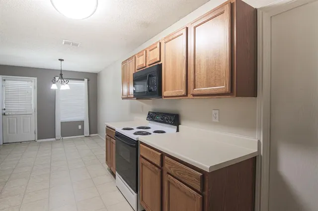 a kitchen that has a cabinets and a stove top oven