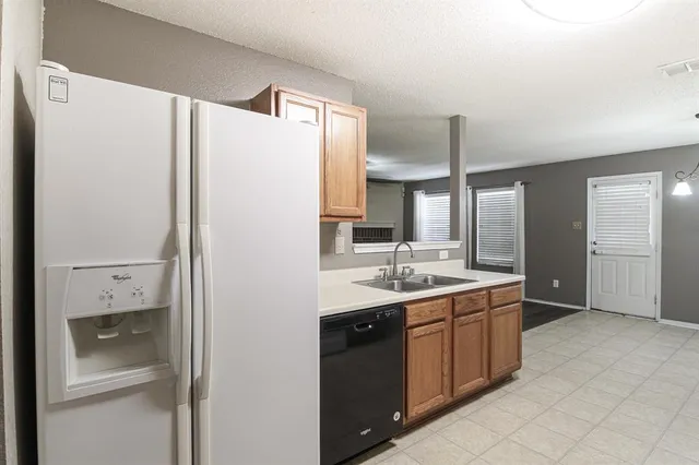 a kitchen with a sink and refrigerator