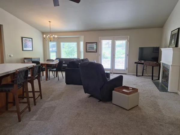 a living room with furniture a window and a flat screen tv