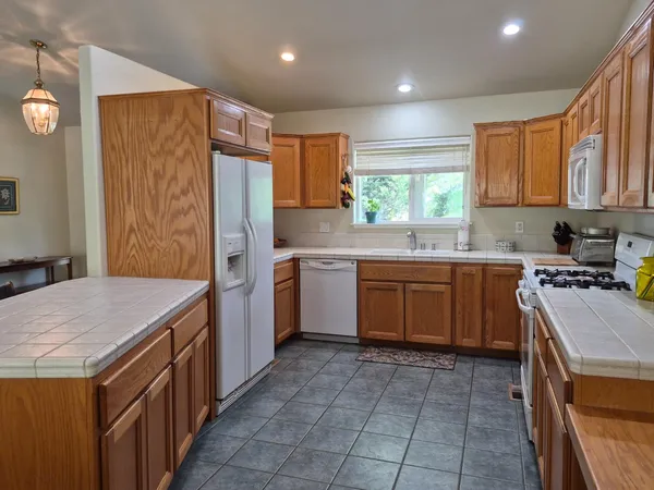 a kitchen with a stove sink and cabinets