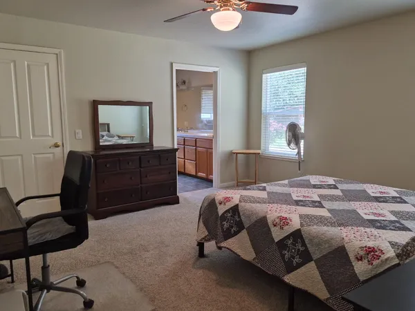 a bedroom with a bed and a television