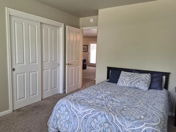 a bedroom with a large bed and a closet