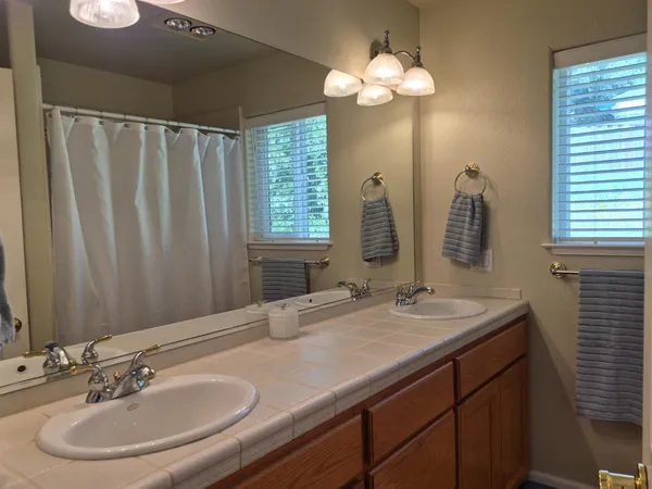a bathroom with 2 sink and a mirror