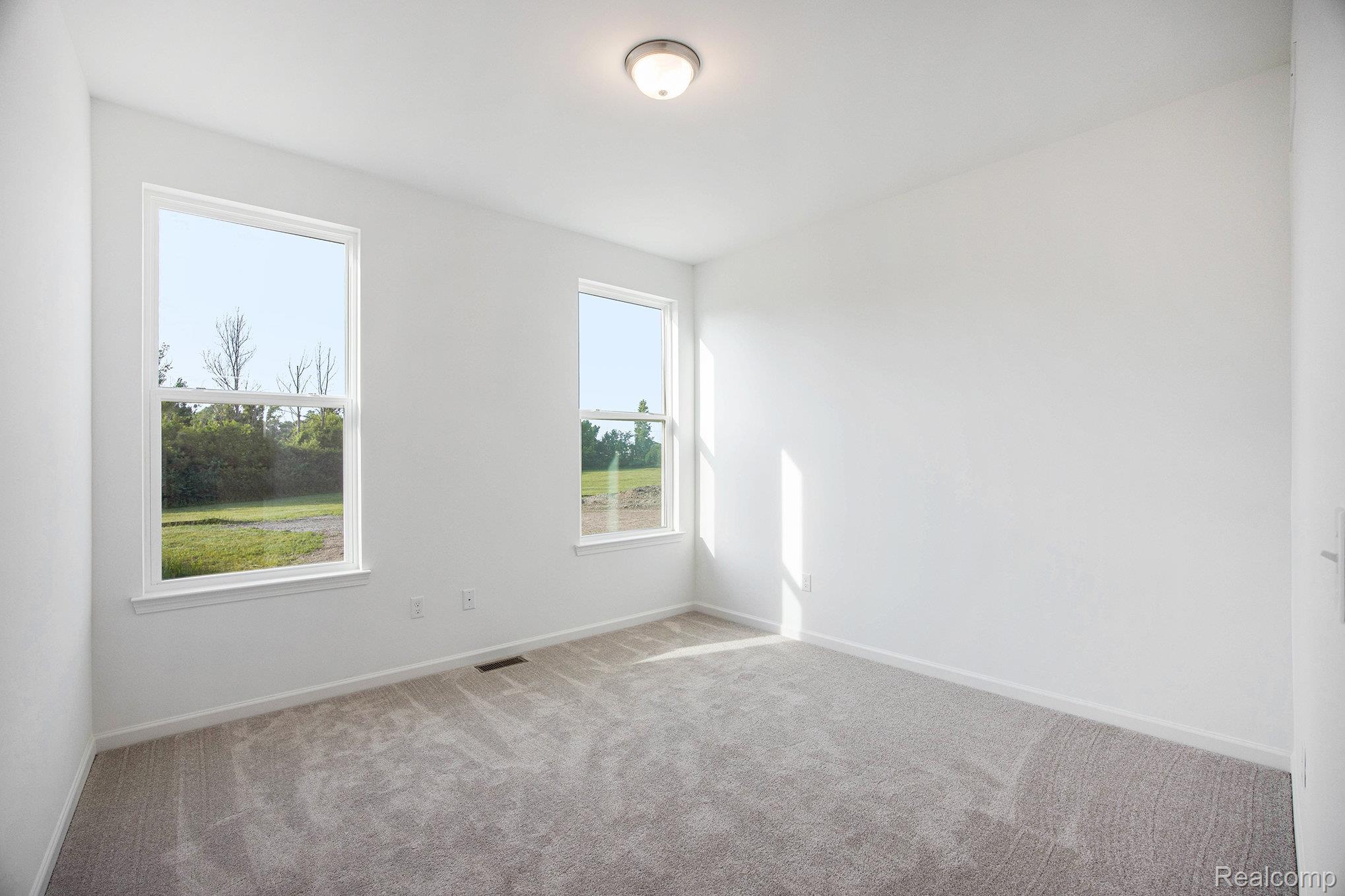 68788 Place Road New Haven, MI 48050 - Photo 22 of 29 Empty room featuring carpet floors and baseboards