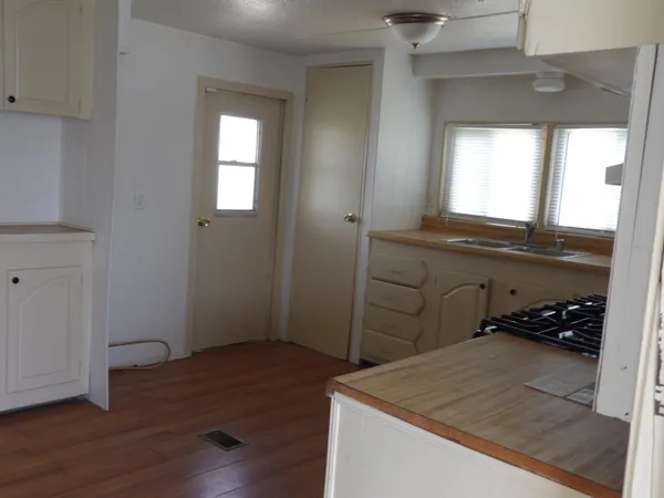 a kitchen with granite countertop a stove and a cabinets