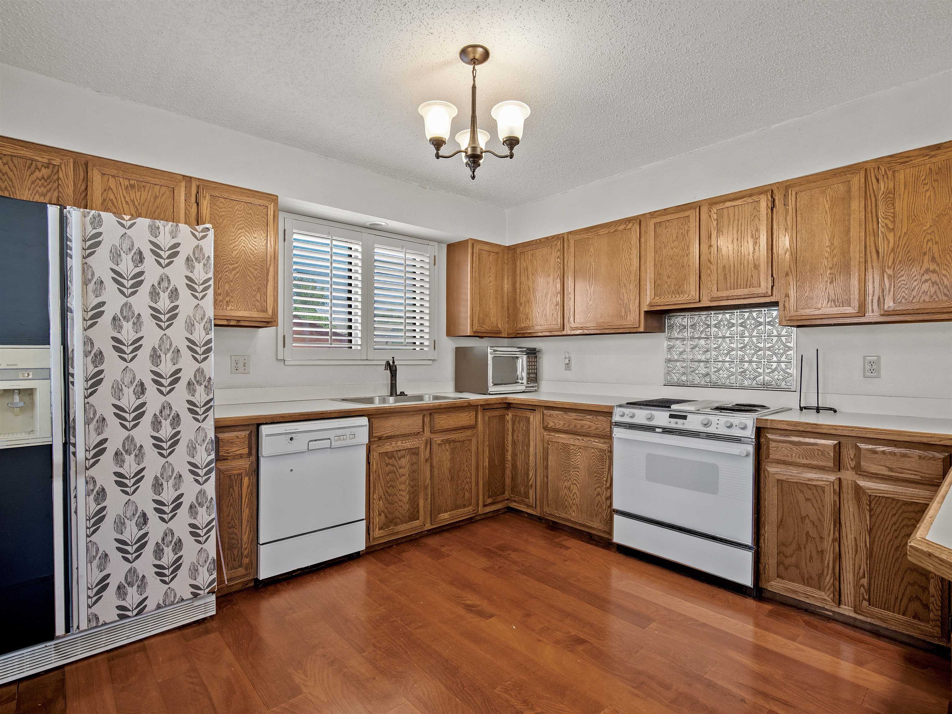 517 Rado Drive, Unit D Grand Junction, CO 81507 - Photo 2 of 24 a kitchen with stainless steel appliances granite countertop a sink stove and wooden cabinets